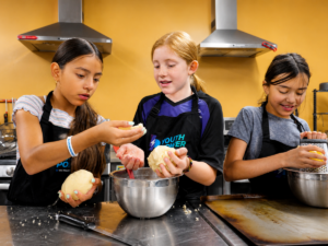 Middle school girls baking during Youth Power's Culinary Program in Eagle County Colorado