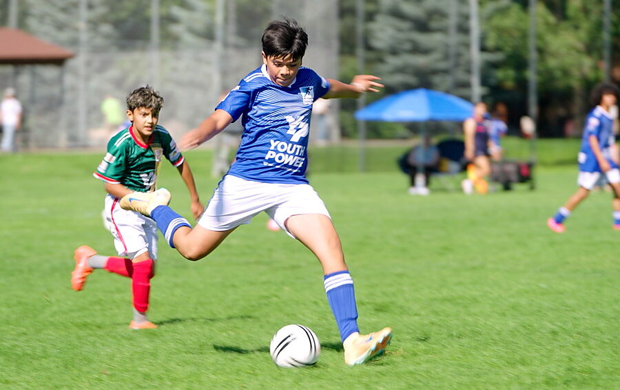 Two boys playing middle school soccer with Youth Power in Eagle County, Colorado