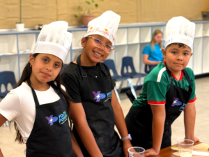 Students in aprons participating in Youth Power's Advanced Culinary Club for Middle School Students